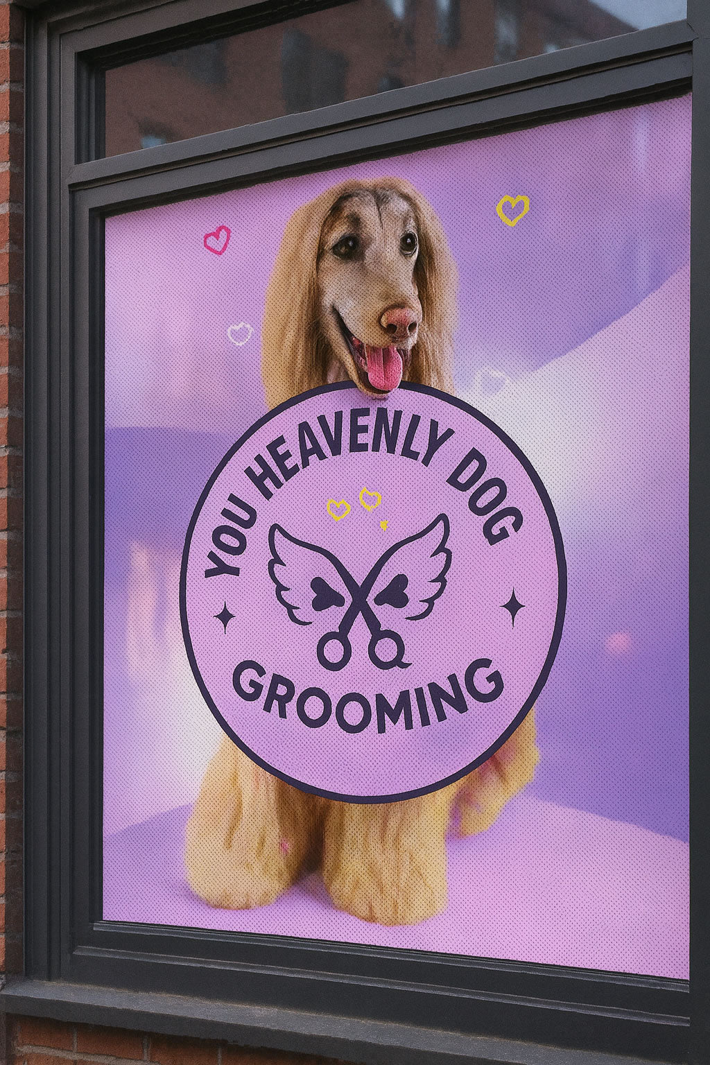 window decal for 'You Heavenly Dog Grooming' with a dog on a purple background.