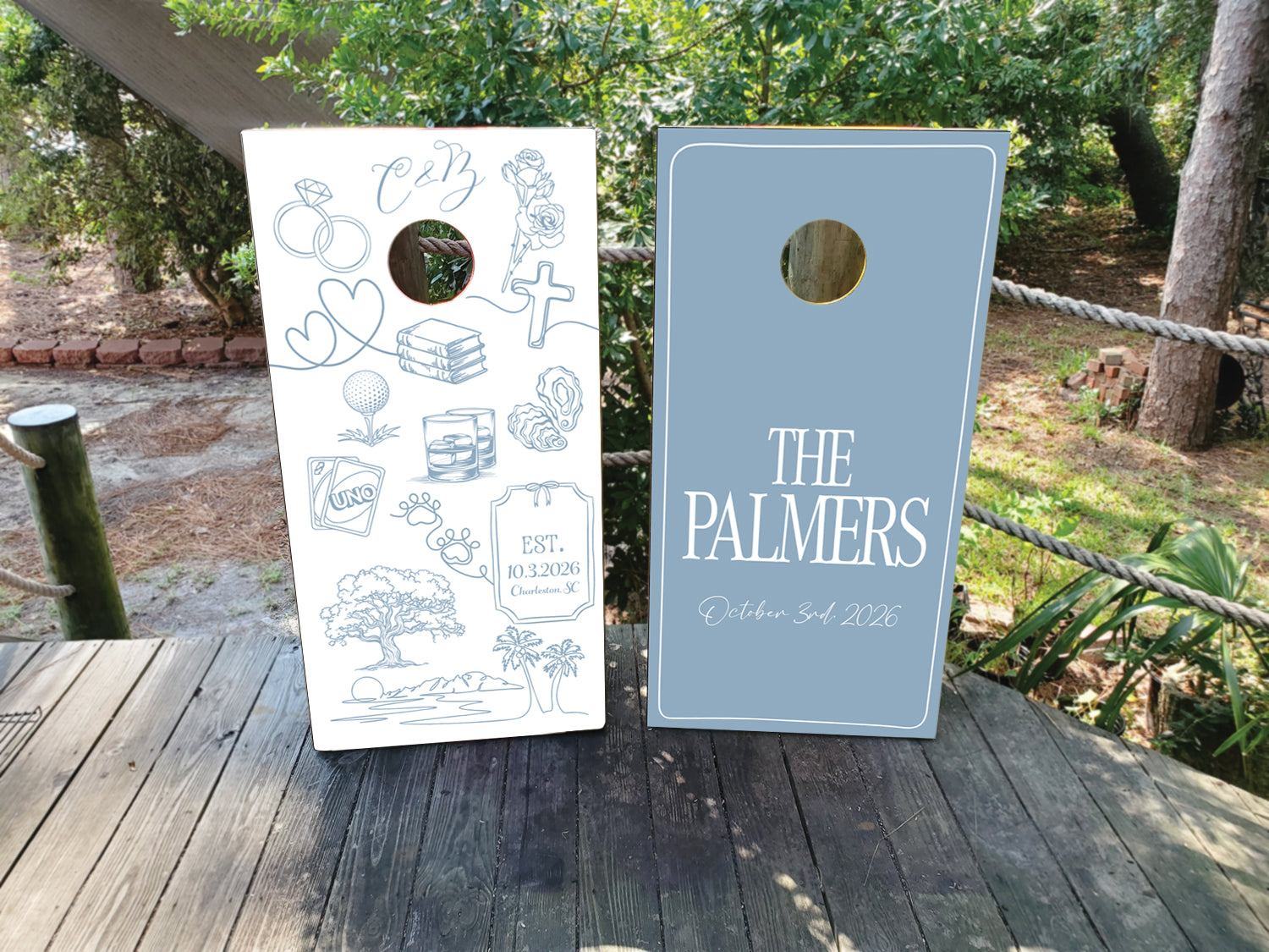 Custom dusty blue and white wedding cornhole wraps with names and custom icons
