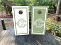 cornhole wraps in a dusty green and white with a custom wedding crest