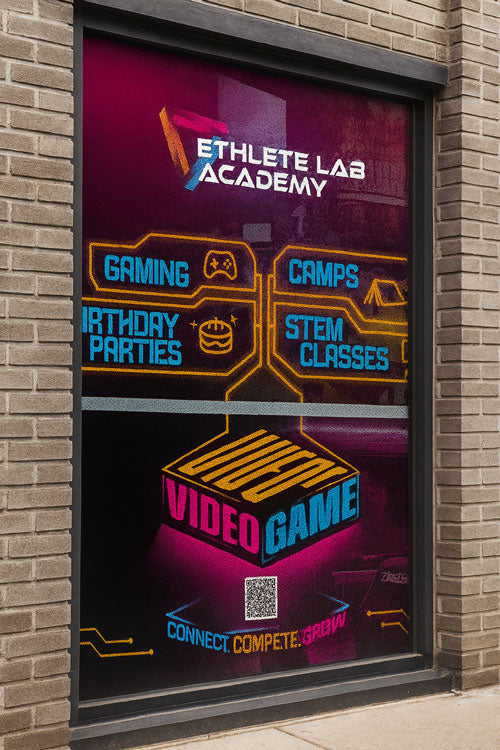 Window display for Athlete Lab Academy with colorful text and graphics on a brick building.