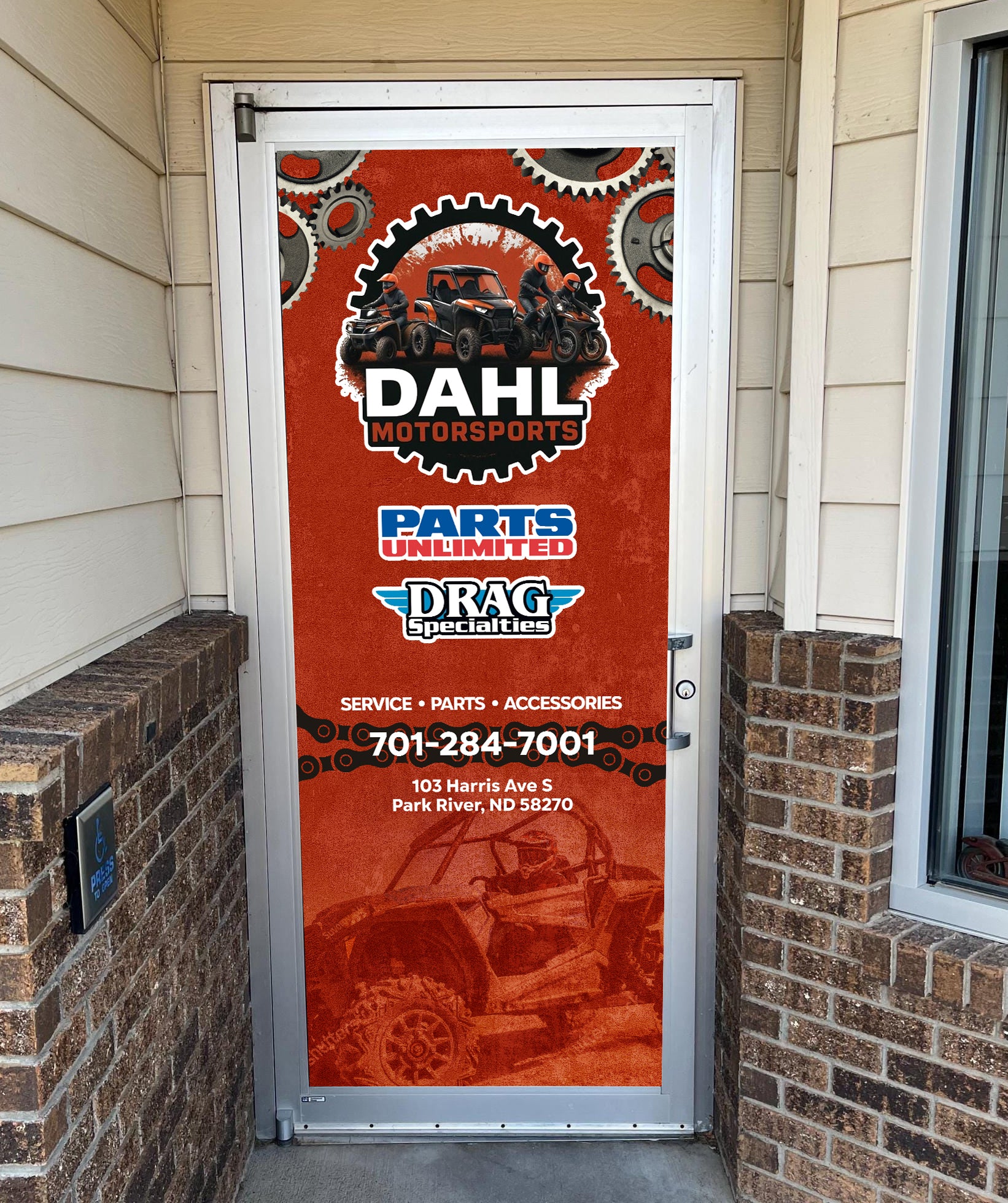 Door with Dahl Motorsports advertisement featuring an off-road vehicle on a red background.