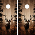 Two cornhole board designs featuring deer in a forest with trees