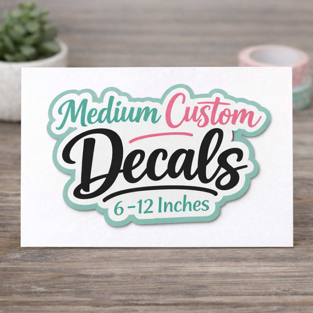 sticker with 'Medium Custom Decals 6-12 Inches' text on a wooden surface with a plant in the background.