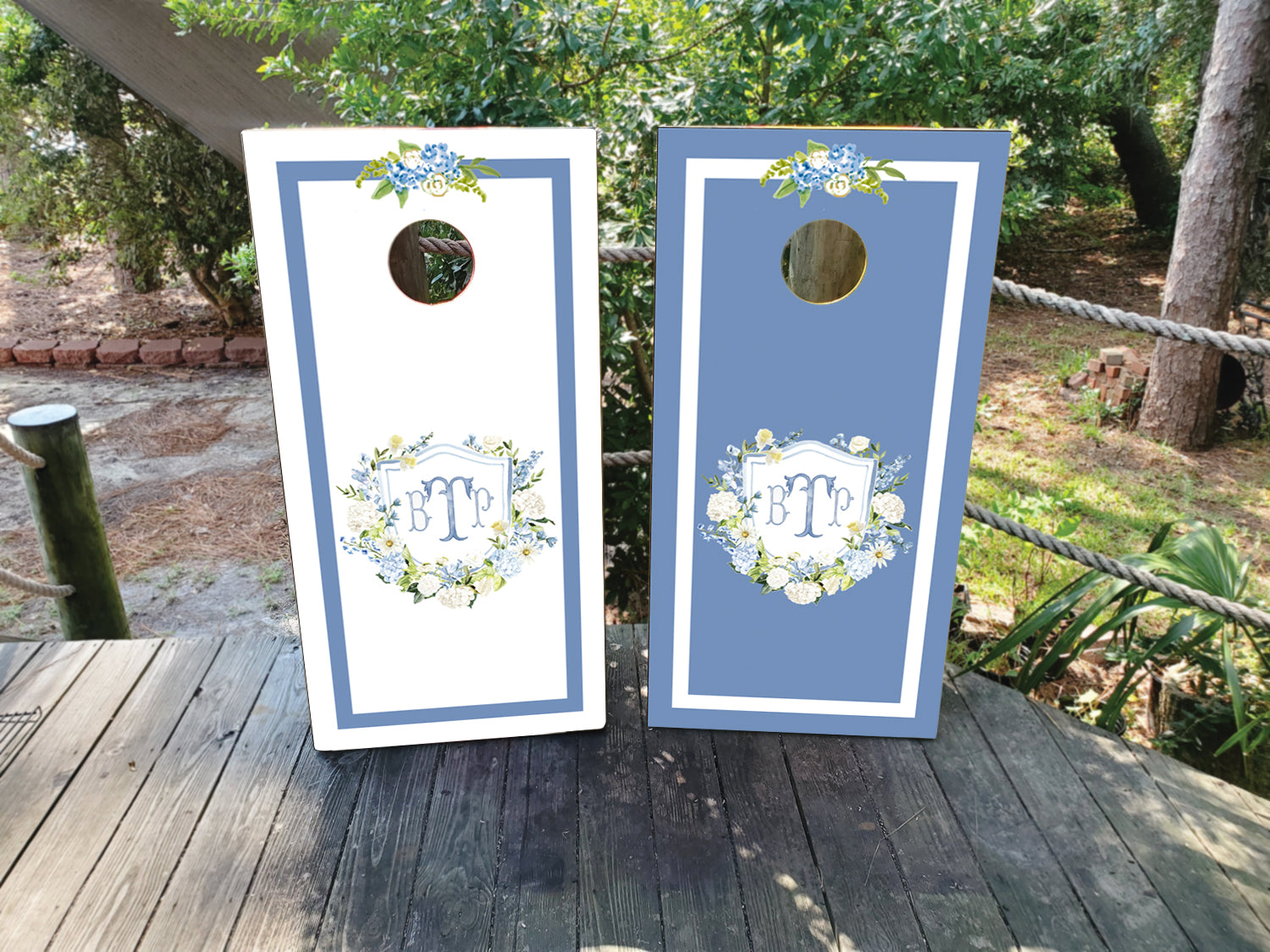 cornhole wraps in a dark blue and white with a custom wedding crest