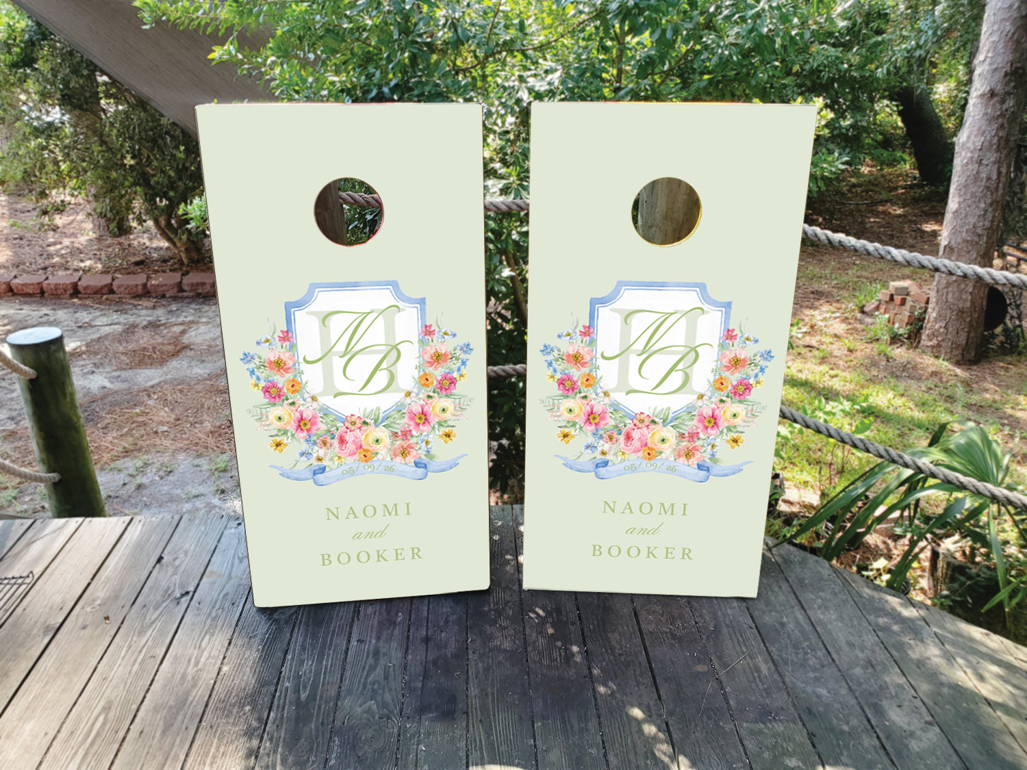 cornhole wraps in a dusty blue and white with a custom wedding crest