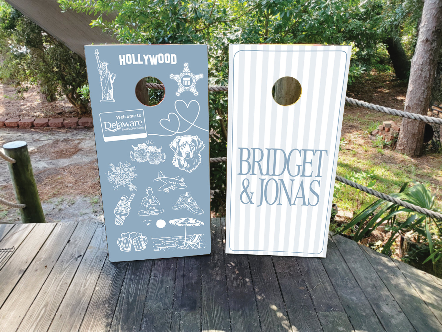 Custom dusty blue and white wedding cornhole wraps with names and custom icons